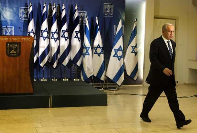 Israeli prime minister Benjamin Netanyahu leaves the room after delivering a statement to the media in Tel Aviv. Israel's prime minister says the army is prepared for a [significant widening] of its operation in the Gaza Strip, and that Israel has [made it clear] it won't tolerate continued rocket fire on its civilians. (Photo by Dan Balilty/Associated Press)