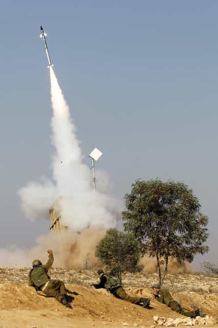 Israeli soldiers watch as an Iron Dome launcher fires an interceptor rocket near the southern city of Beersheba. Hamas fired dozens of rockets into southern Israel on Thursday, killing three people, and Israel launched numerous air strikes across the Gaza Strip, threatening a wider offensive to halt repeated Palestinian salvoes. (Photo by Baz Ratner/Reuters photo)