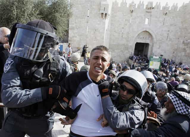 Israeli border police officers detain a Palestinian demonstrator during clashes after a protest against Israel's military operation in Gaza, outside Damascus Gate in Jerusalem's Old City. The latest upsurge in a long-running conflict was triggered on November 14 when Israel killed Hamas's military mastermind, Ahmed Al-Jaabari, in a precision air strike on his car. Israel then began shelling the enclave from land, air and sea. (Photo by Ammar Awad/Reuters)