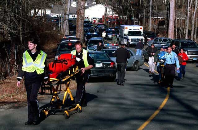 Paramedics push stretchers toward Sandy Hook Elementary School . (Photo by Shannon Hicks/Newtown Bee)