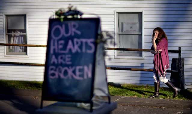 Shop owner Tamara Doherty, paces outside her store just down the road from Sandy Hook Elementary School on Saturday. (Photo by David Goldman/Asaociated Pess)