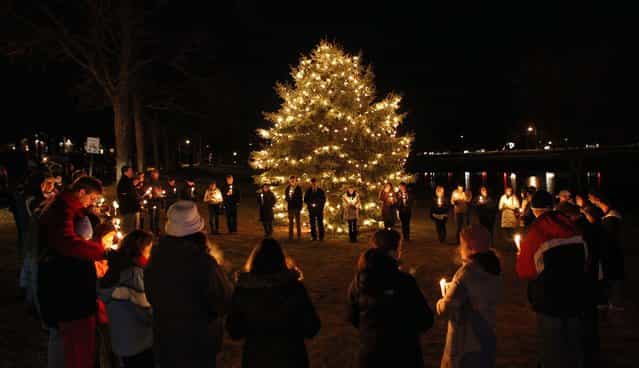 Mourners gather for a candlelight vigil at Ram's Pasture in Newtown to remember the shooting victims. (Photo by Jason DeCrow/Associated Press)