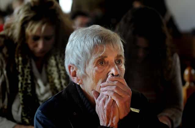 Lee Paulsen listens to a healing service held at St. John's Episcopal Church in Newtown. (Photo by Cloe Poisson/Hartford Courant/MCT)