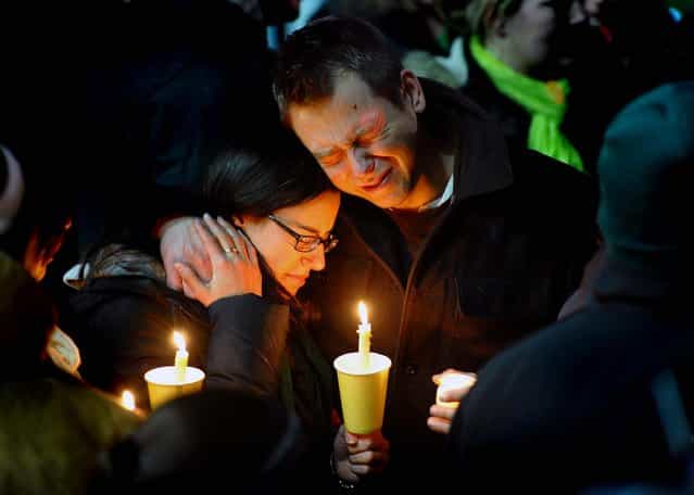 Ted Kowalczuk, of Milford, and his friend Rachel Schiavone, of Norwalk, attend a candlelight vigil held behind Stratford High School on the Town Hall Green in Stratford, Connecticut. Kowalczuk and Schiavone were close friends of Stratford High graduate Vicki Soto, a teacher at Sandy Hook Elementary School who was killed Friday. (Photo by Christian Abraham/The Connecticut Post)