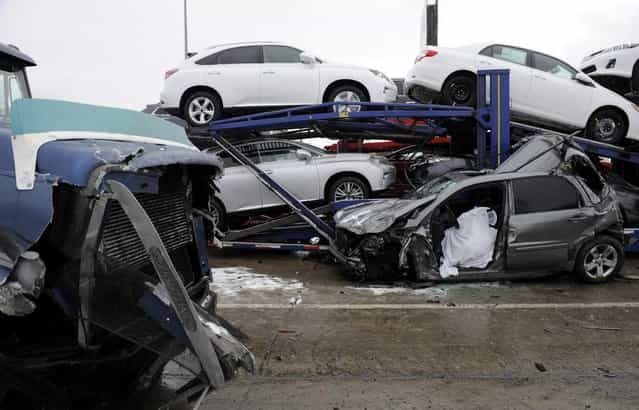 A section of multi-vehicle accident on Interstate 75 is shown in Detroit, Thursday, January 31, 2013. Snow squalls and slippery roads led to a series of accidents that left at least three people dead and 20 injured on a mile-long stretch of southbound I-75. More than two dozen vehicles, including tractor-trailers, were involved in the pileups. (Photo by David Coates/The Detroit News/AP Photo)