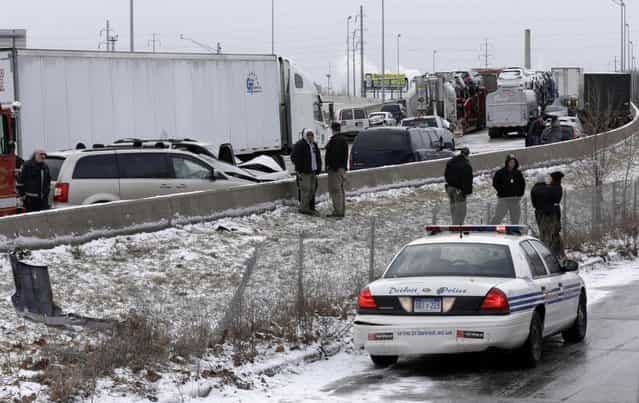 A section of multi-vehicle accident on Interstate 75 is shown in Detroit, Thursday, January 31, 2013. Snow squalls and slippery roads led to a series of accidents that left at least three people dead and 20 injured on a mile-long stretch of southbound I-75. More than two dozen vehicles, including tractor-trailers, were involved in the pileups. (Photo by Paul Sancya/AP Photo)