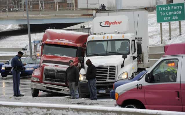 Traffic is at a stand still as emergency personnel responds to a multi-vehicle accident on Interstate 75 in Detroit, Thursday, January 31, 2013. Snow squalls and slippery roads led to a series of accidents that left at least three people dead and 20 injured on a mile-long stretch of southbound I-75. More than two dozen vehicles, including tractor-trailers, were involved in the pileups. (Photo by David Coates/The Detroit News/AP Photo)