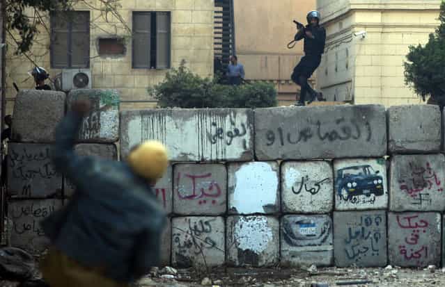 Egyptian protesters clash with riot police near Tahrir Square, Cairo, on January 26, 2013. (Photo by Khalil Hamra/AP Photo/The Atlantic)