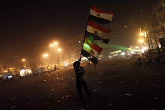 An Egyptian protester waves his national flag in Cairo's Tahrir square on January 25, 2013. Protesters stormed a regional government headquarters and clashed with police as mass rallies shook Egypt on the second anniversary of a revolt that ousted Hosni Mubarak and brought Islamists to power. (Photo by Mahmoud Khaled/AFP Photo/The Atlantic)