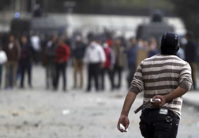 A protester opposing Egyptian President Mohamed Morsi holds a homemade gun during clashes with riot police, along Qasr Al Nil bridge, in Cairo, on January 27, 2013. (Photo by Amr Abdallah Dalsh/Reuters/The Atlantic)
