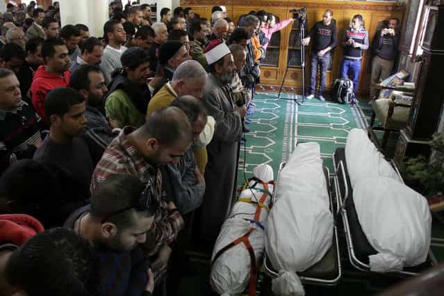 Egyptians say funeral prayers in a mosque for three people who died in demonstrations marking the second anniversary of the January, 25, 2011, Egyptian revolution in Suez, Egypt, on January 26, 2013. (Photo by Ahmed Abd El-Latef/Shorouk Newspaper/AP Photo/The Atlantic)