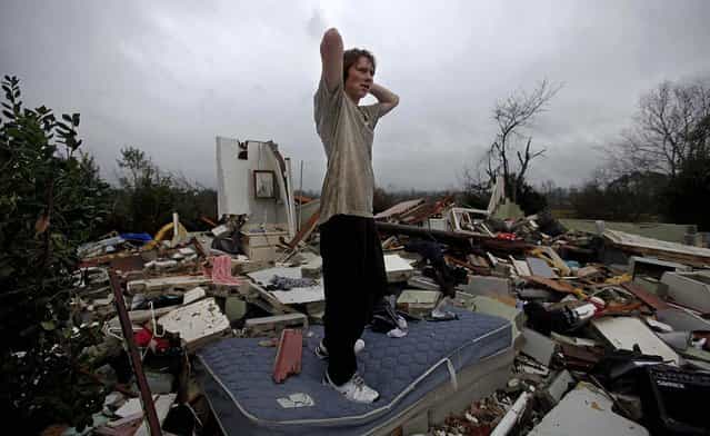 Will Carter, 15, surveys the damage to his house upon arriving home from school after a tornado tore through Adairsville, Georgia. (Photo by David Goldman/Associated Press)