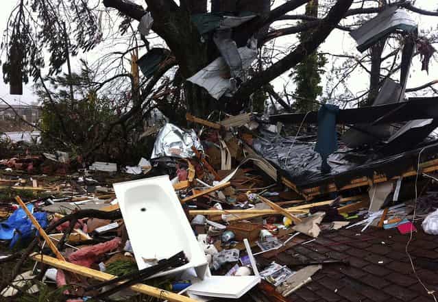 Debris lies in yard in Adairsville. (Photo by David Goldman/Associated Press)