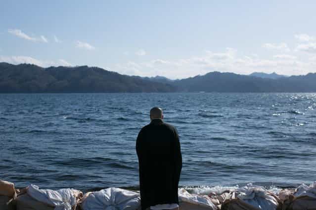 A Buddhist monk prays toward the sea on March 11, 2013 in Ootsuti, Iwate prefecture, Japan. On March 11 Japan commemorates the second anniversary of the magnitude 9.0 earthquake and tsunami that claimed more than 18,000 lives. (Photo by Ken Ishii/AP Photo)
