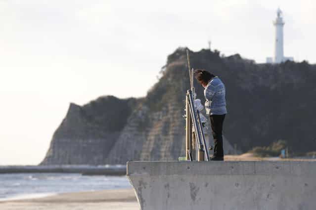 A woman on the coast of Tairausuiso in Iwaki, Fukushima Prefecture, prays Monday for family members killed in the earthquake and tsunami on March 11, 2011. (Photo by KYODO)
