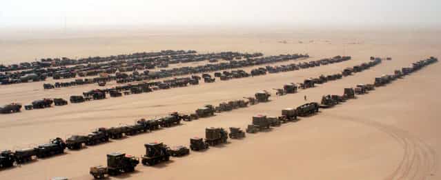 An assault convoy of trucks and armored vehicles of the 101st Airborne Division's 3rd Brigade Combat Team prepare to cross into Iraq, on March 21, 2003. (Photo by Robert Woodward/Reuters/US Army/The Atlantic)