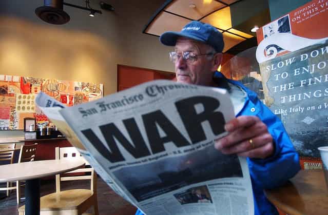 Ray Jacques reads the San Francisco Chronicle's war special section inside a Starbucks coffee shop in San Francisco, in this March 20, 2003 photo. (Photo by Marcio Jose Sanchez/AP Photo/The Atlantic)