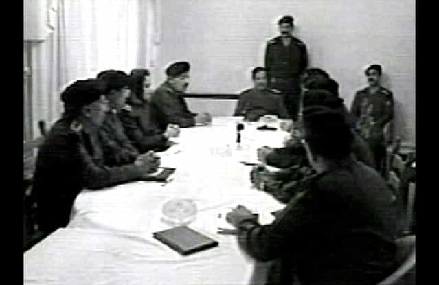 In this image from video seen on Iraqi television on March 27, 2003, Iraqi President Saddam Hussein meets with high-ranking Ba'ath party officials. (Photo by AP Photo/Iraqi TV/APTN/The Atlantic)