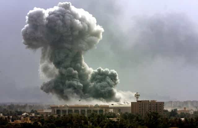 Smoke billows from a building hit during coalition forces air raid in Baghdad, on Monday March 31, 2003. (Photo by Jerome Delay/AP Photo/The Atlantic)