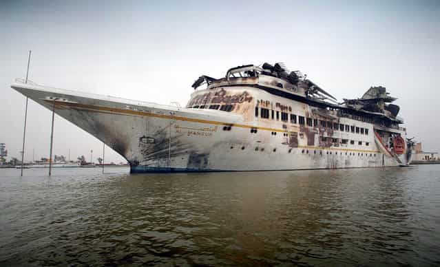 The damaged [Al Mansur], Iraqi President Saddam Hussein's private yacht, anchored in central Basra, on April 10, 2003. (Photo by Simon Walker/Reuters/The Atlantic)