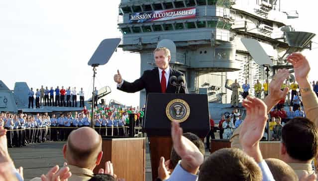 President Bush gives a thumbs-up sign after declaring the end of major combat in Iraq as he speaks aboard the aircraft carrier USS Abraham Lincoln off the California coast, on May 1, 2003. (Photo by J. Scott Applewhite/AP Photo/The Atlantic)