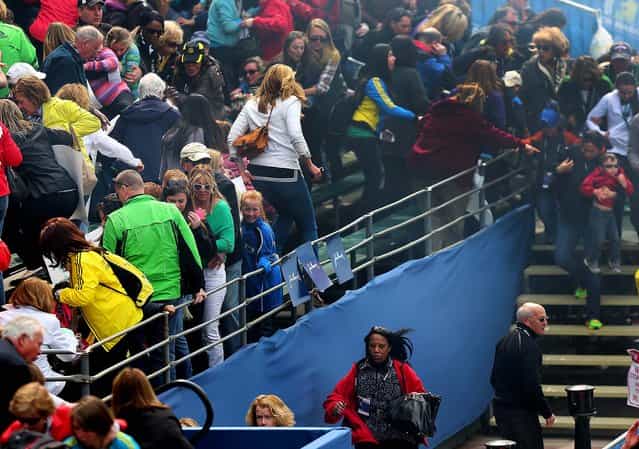Spectators rush to leave the stands after an explosion at the Boston Marathon, April 15, 2013. (Photo by David L. Ryan/The Boston Globe)