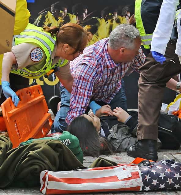 Medical workers aid injured people at the 2013 Boston Marathon following an explosion in Boston, Monday, April 15, 2013. (Photo by David L. Ryan/AP Photo/The Boston Globe)