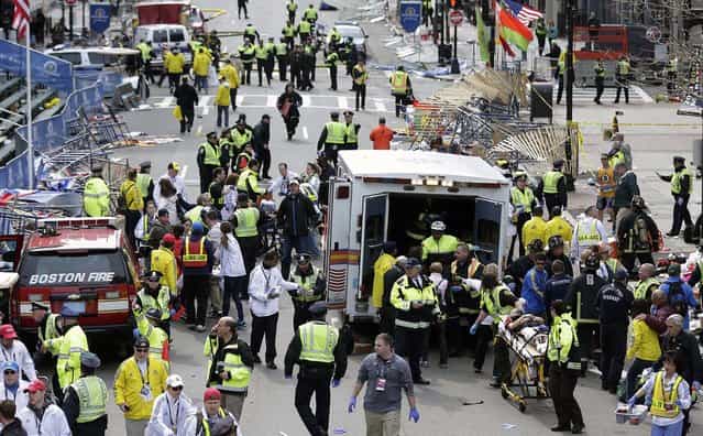Medical workers aid those injured at the finish line of the 2013 Boston Marathon. (Photo by Charles Krupa/Associated Press)