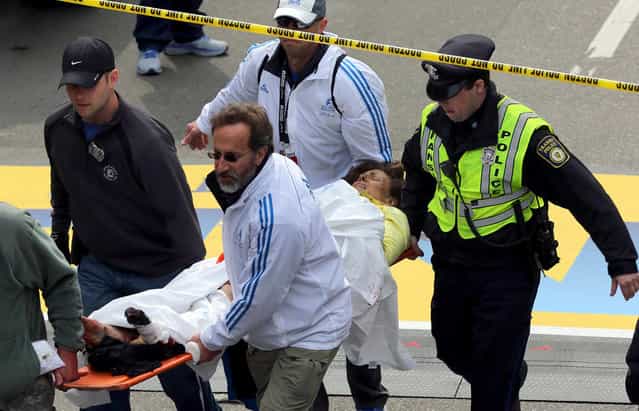 Medical workers aid injured people at the finish line of the 2013 Boston Marathon following an explosion in Boston, Monday, April 15, 2013. (Photo by David L. Ryan/AP Photo/The Boston Globe)
