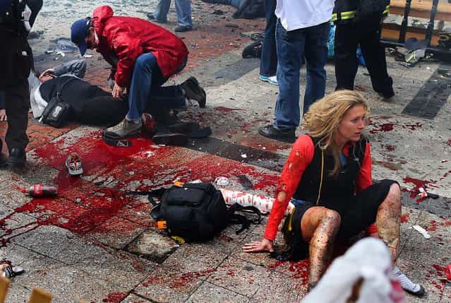 The scene moments after the first explosion near the finish line of the Boston Marathon. (Photo by John Tlumacki/The Boston Globe)