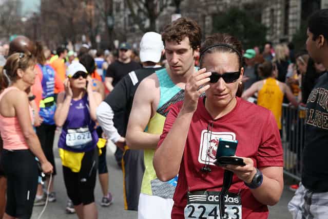 Runners react near Kenmore Square after two bombs exploded during the 117th Boston Marathon on April 15, 2013 in Boston, Massachusetts. (Photo by Alex Trautwig)