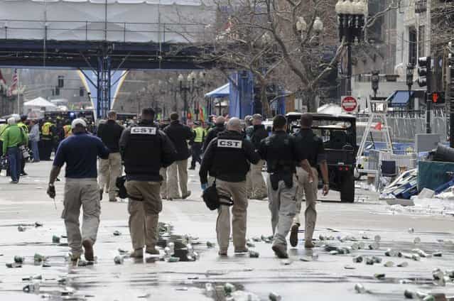 Public safety officials evacuate the scene after several explosions near the finish line of the 117th Boston Marathon in Boston, Massachusetts April 15, 2013. (Photo by Neal Hamberg/Reuters)