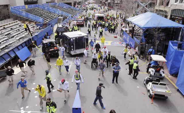 Police clear the area at the finish line of the 2013 Boston Marathon following an explosion in Boston, Monday, April 15, 2013. (Photo by Charles Krupa/AP Photo)