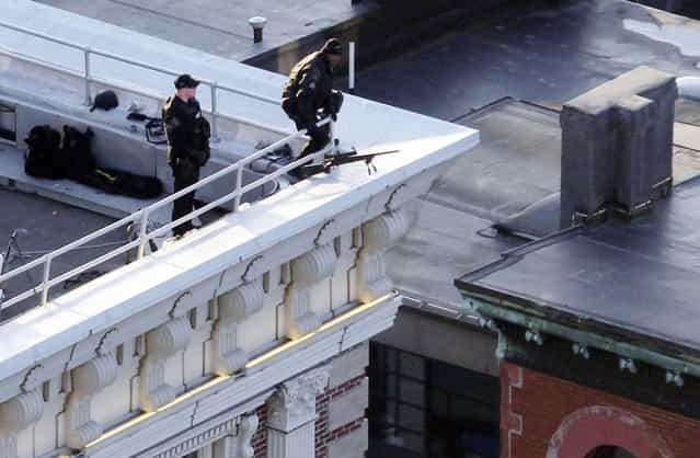 Police are seen on the roof of a building overlooking Boylston Street where explosions went off at the 117th Boston Marathon in Boston, Massachusetts April 15, 2013. (Photo by Jessica Rinaldi/Reuters)
