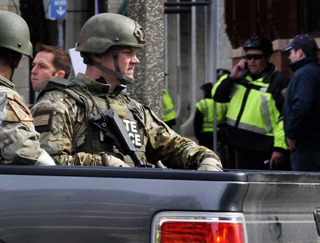 Armed Massachusetts State Police roll into the area following the explosions. (Photo by Josh Reynolds/Associated Press)