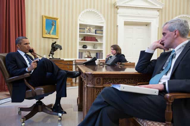 In this handout provided by the White House, U.S. President Barack Obama (L) talks on the phone with FBI Director Robert Mueller to receive an update on the explosions that occurred in Boston, in the Oval Office of the White House, April 15, 2013 in Washinton, DC. Seated with the President are Lisa Monaco, Assistant to the President for Homeland Security and Counterterrorism, and Chief of Staff Denis McDonough. Two people are confirmed dead and at least 23 injured after two explosions went off near the finish line to the marathon. (Photo by Pete Souza/The White House)