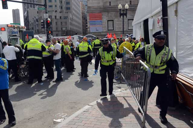 Emergency personnel take postion at the finish line after two bombs exploded during the 117th Boston Marathon on April 15, 2013 in Boston, Massachusetts. (Photo by Darren McCollester/AFP Photo)