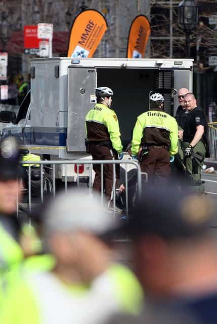 Boston Police guard an area at the one mile checkpoint near Kenmore Square after two bombs exploded during the 117th Boston Marathon on April 15, 2013 in Boston, Massachusetts. Two people are confirmed dead and at least 23 injured after two explosions went off near the finish line to the marathon. (Photo by Alex Trautwig)