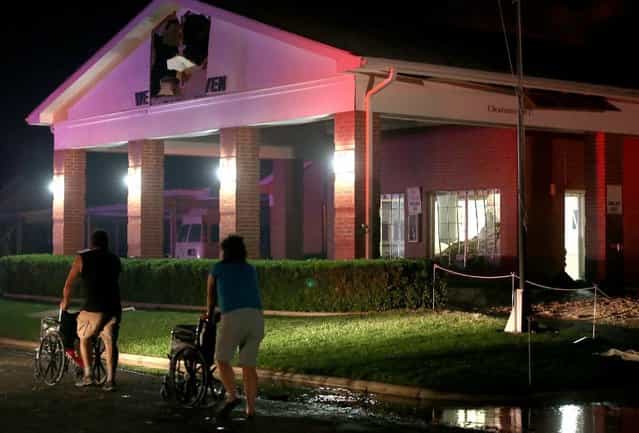 Persons are seen pushing wheel chairs in front of a damaged nursing home following an explosion at a nearby fertilizer plant Wednesday, April 17, 2013, in West, Texas. An explosion at a fertilizer plant near Waco caused numerous injuries and sent flames shooting high into the night sky on Wednesday. (Photo by Rod Aydelotte/AP Photo/ Waco Tribune Herald)