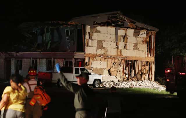 Rescue workers work near a damaged apartment complex after a nearby fertilizer plant exploded Wednesday, April 17, 2013, in West, Texas. (Photo by Rod Aydelotte/AP Photo/Waco Tribune Herald)