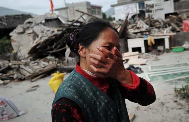 A woman reacts after her house was damaged by an earthquake in Lushan county in China's Sichuan province, on April 20, 2013. The powerful earthquake struck the area nearly five years after a devastating quake wreaked widespread damage across the region. (Photo by Associated Press)