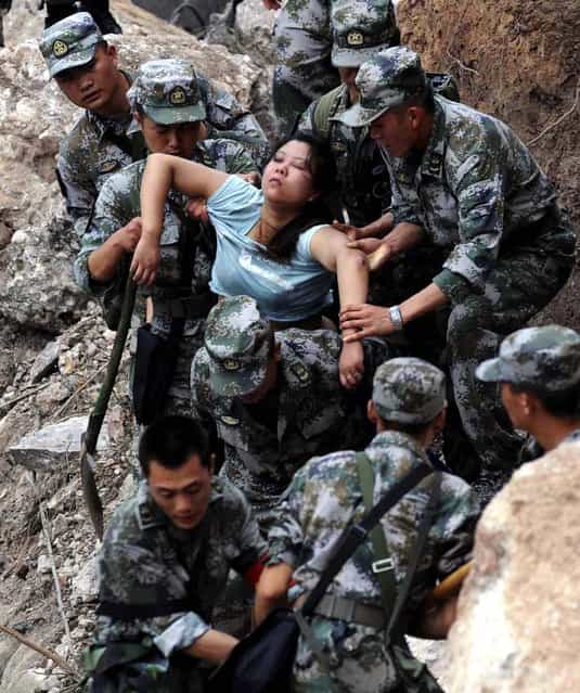 Rescuers save an injured woman after an earthquake hit Baosheng Township in Lushan County in China's Sichuan Province, on April 20, 2013. (Photo by Jiang Hongjing/Xinhua)