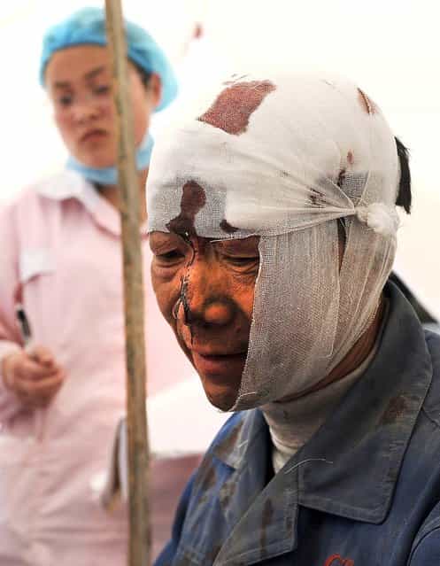 An injured man rests at a temporary treatment station following the earthquake in southwest China's Sichuan province, on April 20, 2013. (Photo by Associated Press)