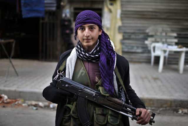 A boy, a member of the Free Syrian Army, poses with his weapon in Aleppo city December 29, 2012. Syria faces [hell] if no deal is struck to end 21 months of bloodshed, an international mediator said on Saturday, but his talks in Russia brought no sign of a breakthrough after a week of intense diplomacy. (Photo by Ahmed Jadallah/Reuters)