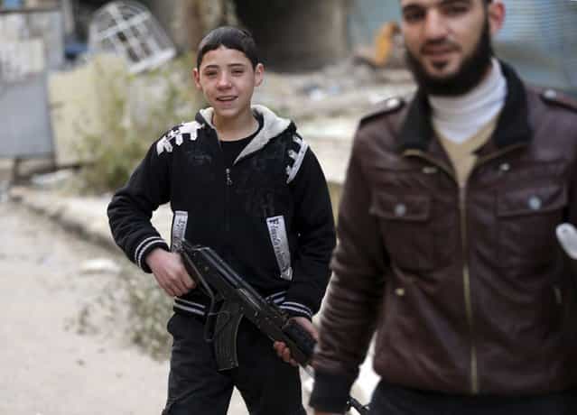 A young Free Syrian Army fighter holds a rifle in Haresta neighbourhood of Damascus January 16, 2013. (Photo by Goran Tomasevic/Reuters)