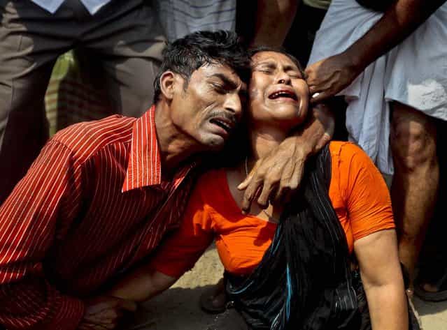 Relatives mourn at the scene of the collapse on Wednesday. (Photo by A. M. Ahad/Associated Press)