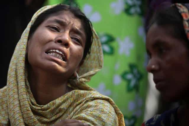 A Bangladeshi relative of a victim cries at the site of a building that collapsed Wednesday in Savar, near Dhaka, Bangladesh,Thursday, April 25, 2013. By Thursday, the death toll reached at least 194 people as rescuers continued to search for injured and missing, after a huge section of an eight-story building that housed several garment factories splintered into a pile of concrete. (Photo by A. M. Ahad/AP Photo)