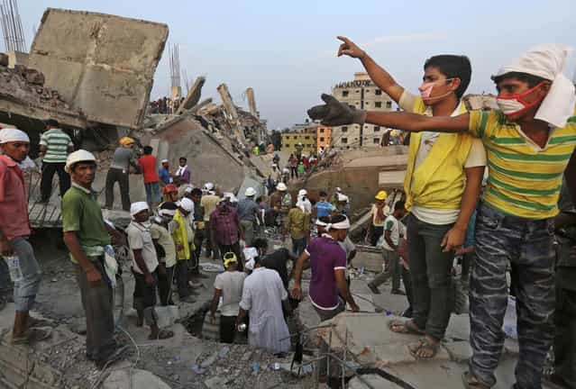 Bangladeshi rescuers from a youth group gesture for help at the site of a building that collapsed Wednesday in Savar, near Dhaka, Bangladesh, Thursday, April 25, 2013. By Thursday, the death toll reached at least 194 people as rescuers continued to search for injured and missing, after a huge section of an eight-story building that housed several garment factories splintered into a pile of concrete. (Photo by Kevin Frayer/AP Photo)