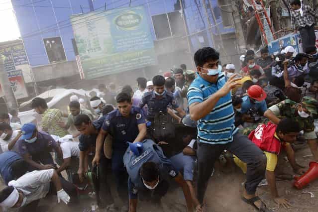 Rescue workers, army personnel, police and members of media run after they heard someone shouting that a building next to Rana Plaza is collapsing during a rescue operation in Savar, 19 miles outside Dhaka April 26, 2013. The search for survivors from Bangladesh’s worst industrial accident stretched into a third day on Friday, with the death toll rising to 273 after the collapse of Rana Plaza. (Photo by Andrew Biraj/Reuters)