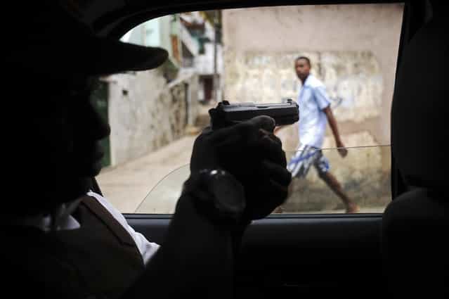 Police patrol in the Nordeste de Amaralina slum complex in Salvador, Bahia State, March 28, 2013. One of Brazil's main tourist destinations and a 2014 World Cup host city, Salvador suffers from an unprecedented wave of violence with an increase of over 250% in the murder rate, according to the Brazilian Center for Latin American Studies (CEBELA). (Photo by Lunae Parracho/Reuters)